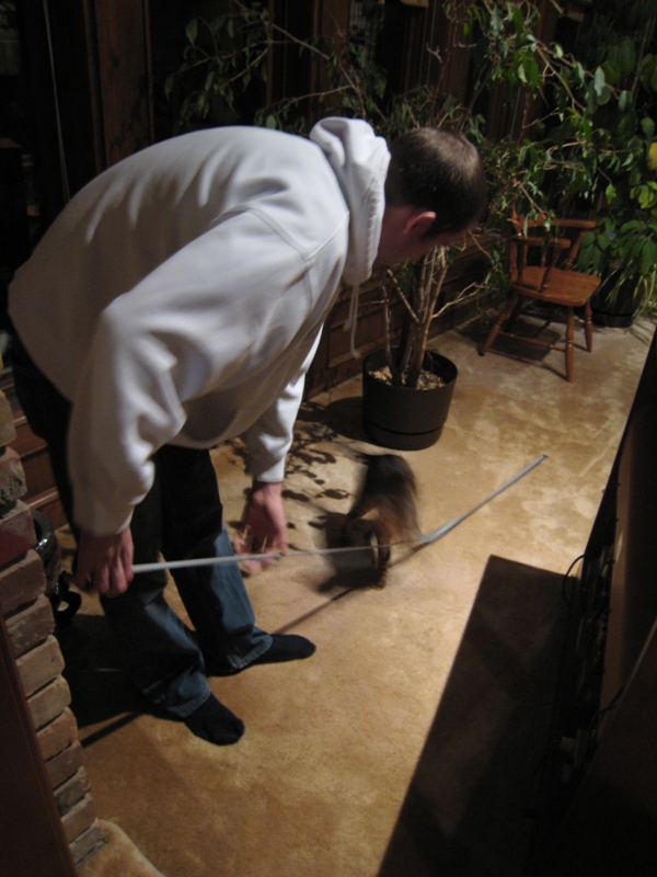 Eric measured the spot for my treadmill while Sketchie attached the measuring tape