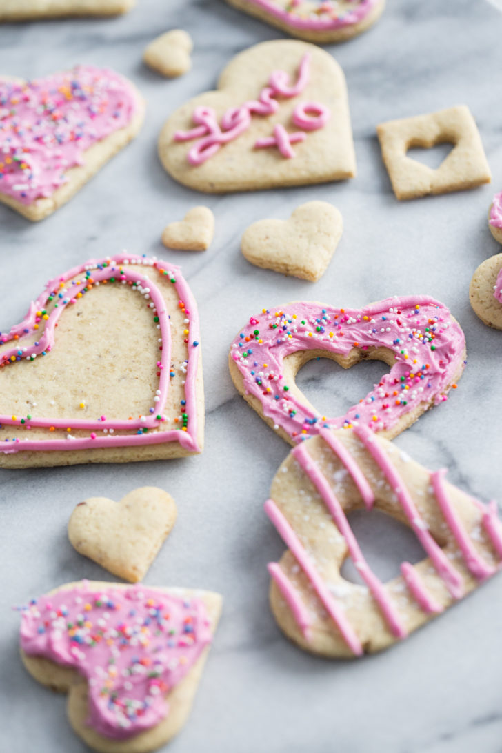 Sugar cookies with pink frosting on marble table