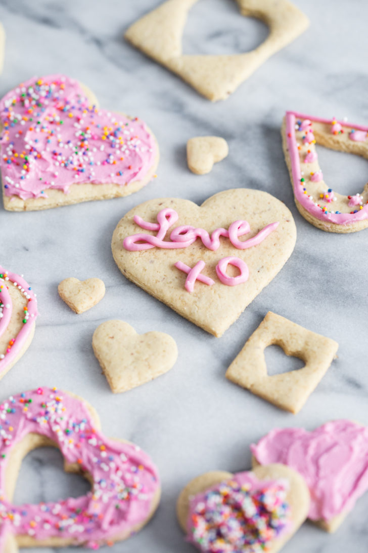 Sugar cookies with pink frosting on marble