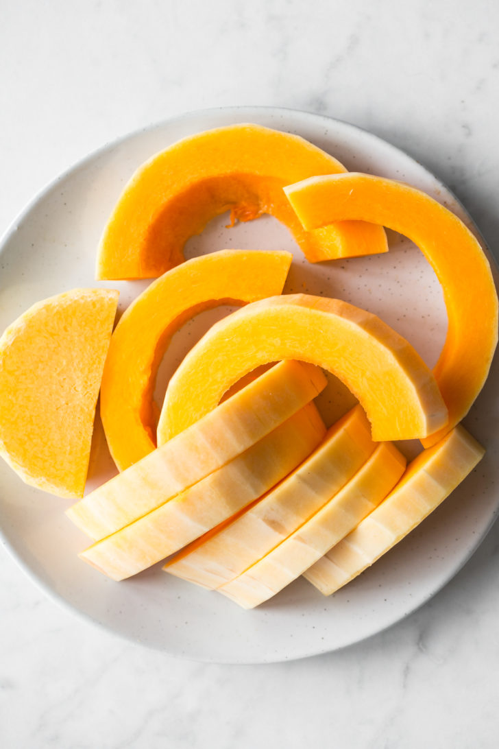 Butternut squash slices on white plate