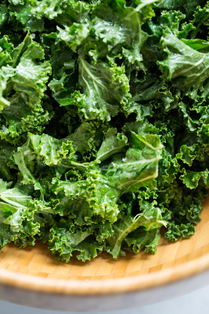 Closeup of kale salad in wood bowl